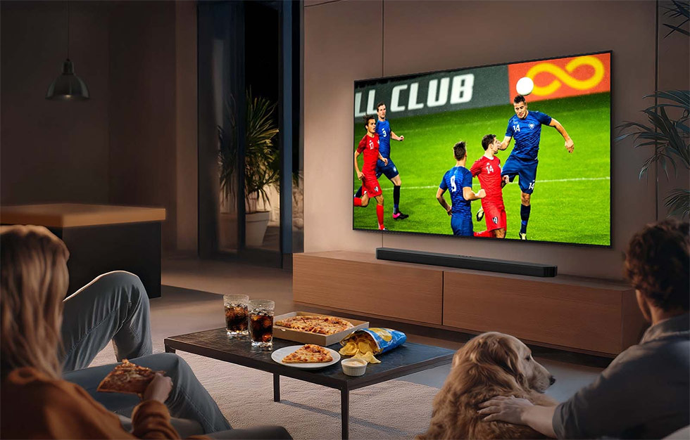 Man cheering while watching a football match at home and holding a phone. Man cheering while watching a football match at home and holding a phone.